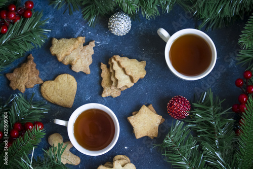 Two cups of tea and christmas cookies on the table, flat lay