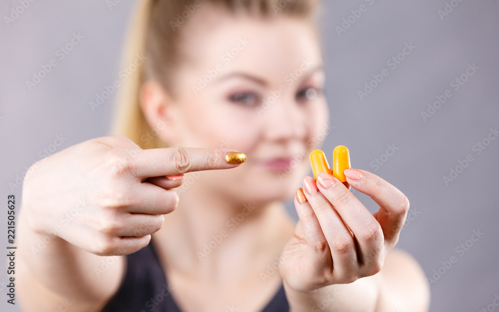 Woman holding protective earplugs Woman holding protective earplugs
