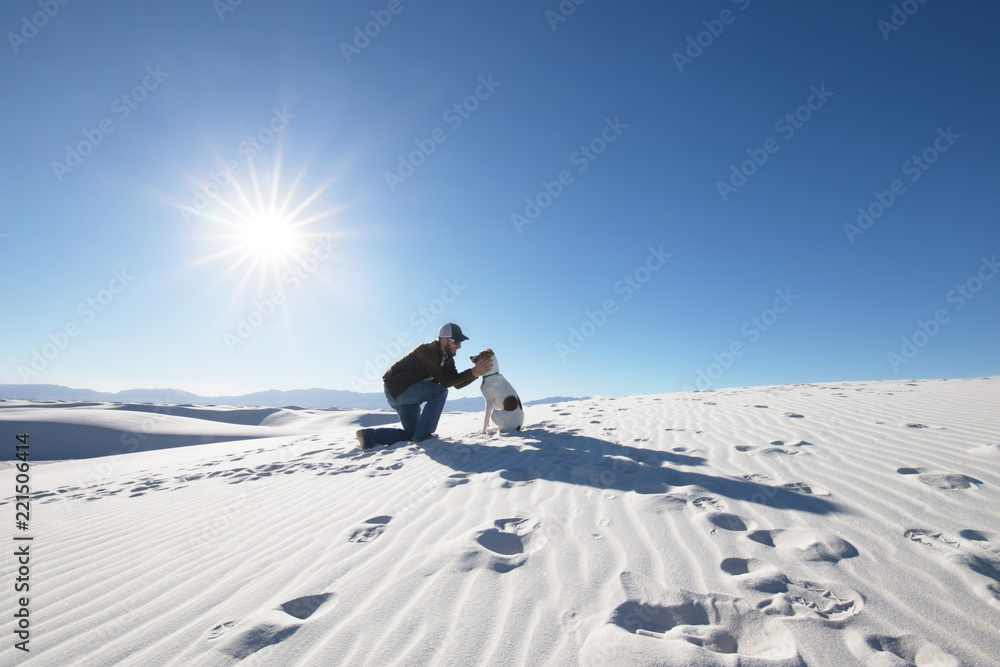 Man playing with dog on vacation