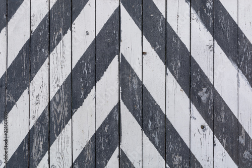 Wooden door to the warehouse, painted in oblique black stripes