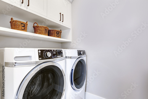 White clean laundry room modern with washer and dryer photo