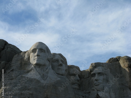 Mount Rushmore in the fall of the year with a beautiful blue sky