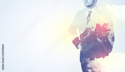 Businessman standing and thinking with snowy mountain graphic
