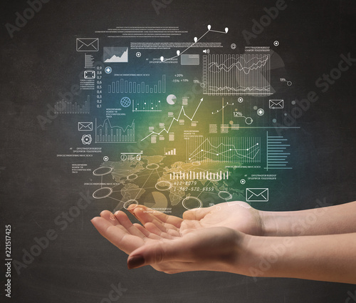 Demographic related charts, diagrams and graphs hovering over young hand