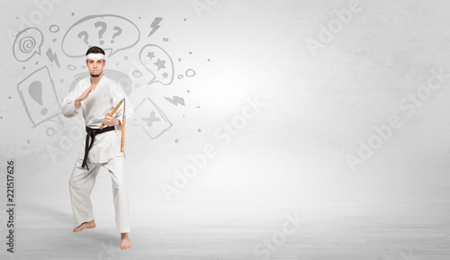 Young kung-fu trainer fighting with doodled symbols concept 
