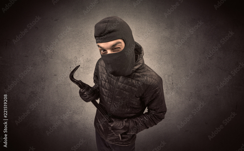 Burglar standing in black clothes and balaclava on his head. Burglar standing in black clothes and balaclava on his head.