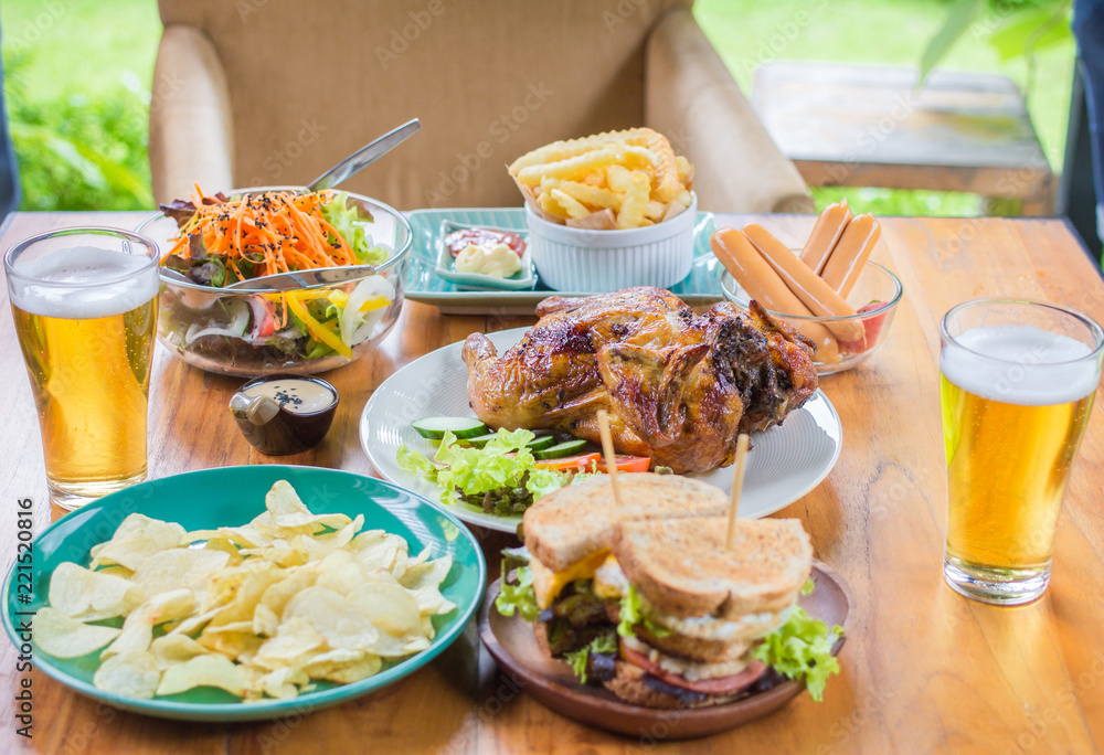 Beer. Dining Concept,With Chicken roasting,salad,French fries on wooden table Beer. Dining Concept,With Chicken roasting,salad,French fries on wooden table