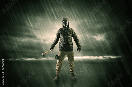 Terrorist in a stormy space with gas mask on his hand and weapons on his arm 