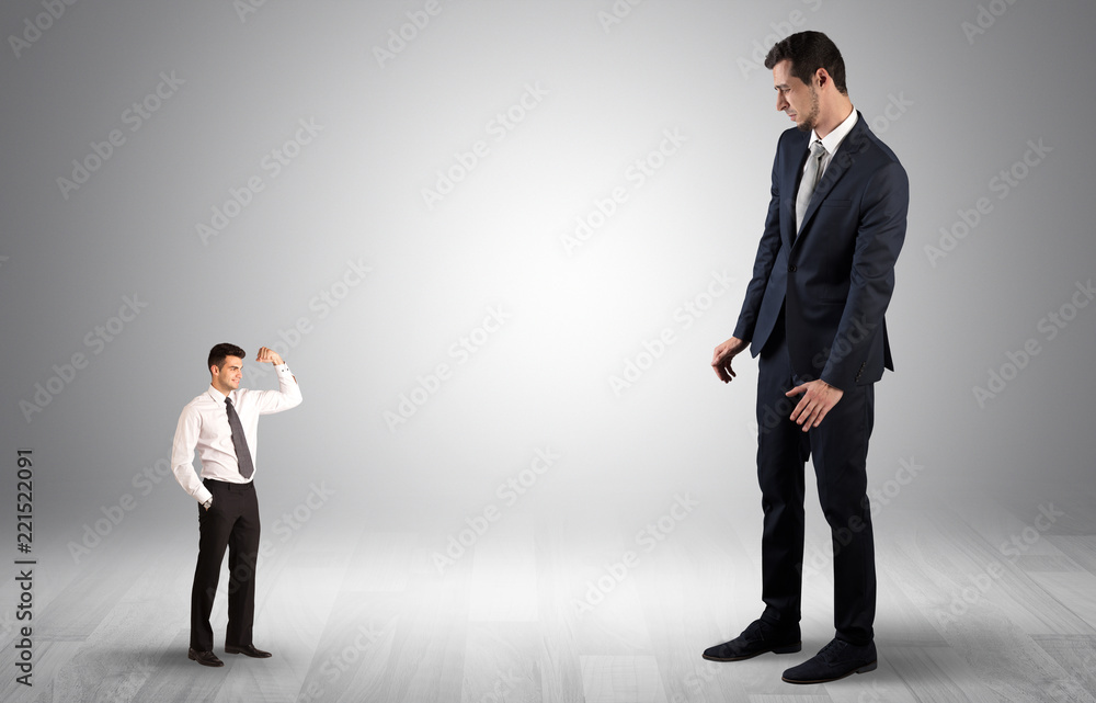 Big debutant young businessman scared of small strong businessman
Big debutant young businessman scared of small strong businessman