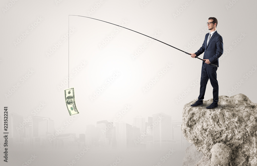 Elegant young businessman fishing cash from a huge rock Elegant young businessman fishing cash from a huge rock