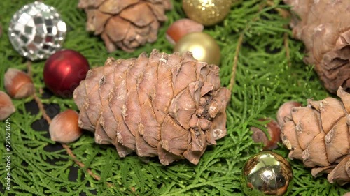 Pinecones and Baubles Rotationg on Fir Tree Branches. Cristmas Background photo