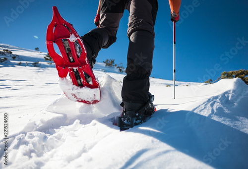 Man in snowshoes in the mountains. photo