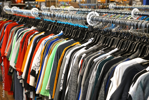 rows of clothes hanging in the rack of store