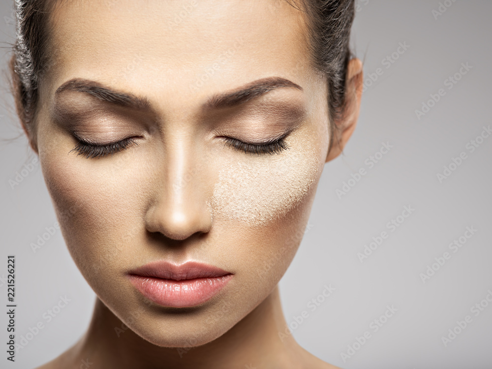 dry cosmetic makeup powder is on the female face. dry cosmetic makeup powder is on the female face.