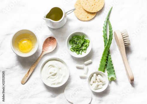 Aloe face mask ingredients -aloe  yogurt  egg  olive oil and beauty accessories on light background  top view. Home recipe. Flat lay