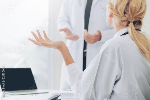 Female doctor at hospital talking to her partner. photo