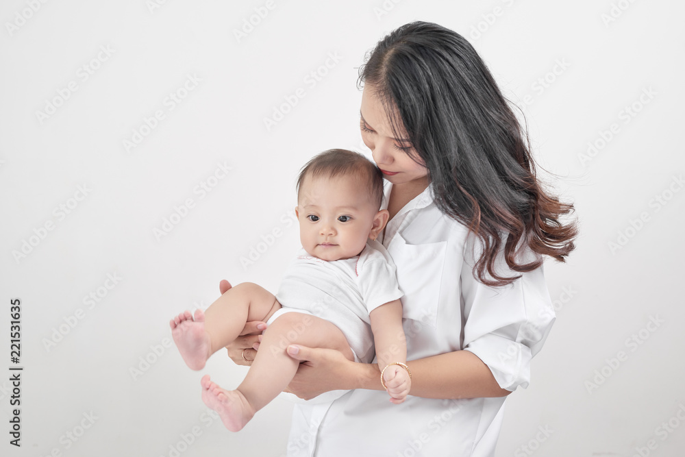 Motherhood and lifestyle concept. Smiling young mother with little baby at home Motherhood and lifestyle concept. Smiling young mother with little baby at home
