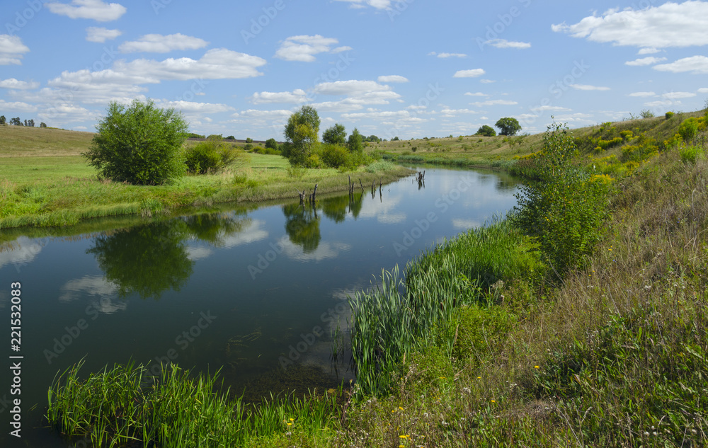 Sunny summer landscape with river,fields,green hills and beautiful clouds in blue sky.River Upa in Tula region,Russia. Sunny summer landscape with river,fields,green hills and beautiful clouds in blue sky.River Upa in Tula region,Russia.