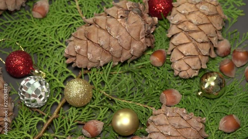 Pinecones and Baubles Rotationg on Fir Tree Branches. Cristmas Background photo