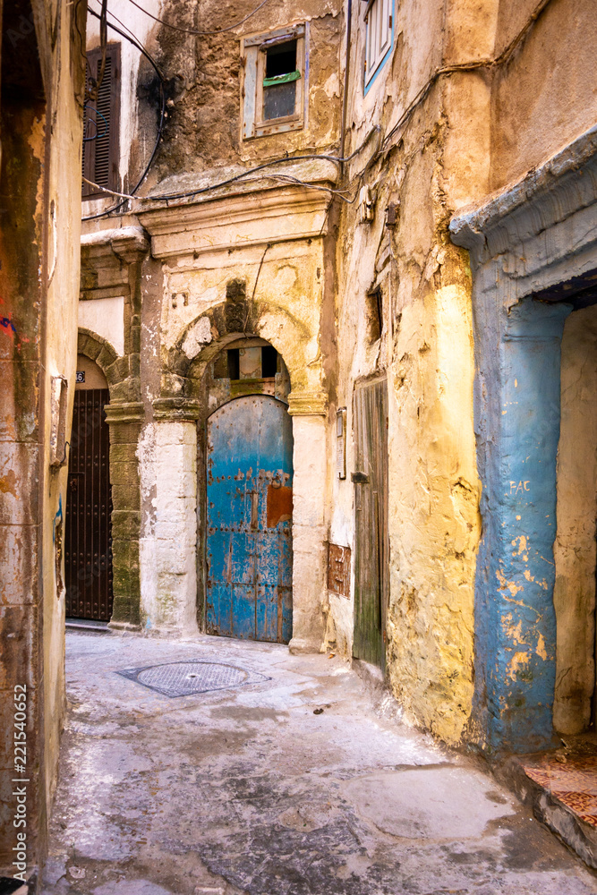 Fototapeta premium The dilapidated buildings of a small street in the Mellah district in Essaouira, Morocco