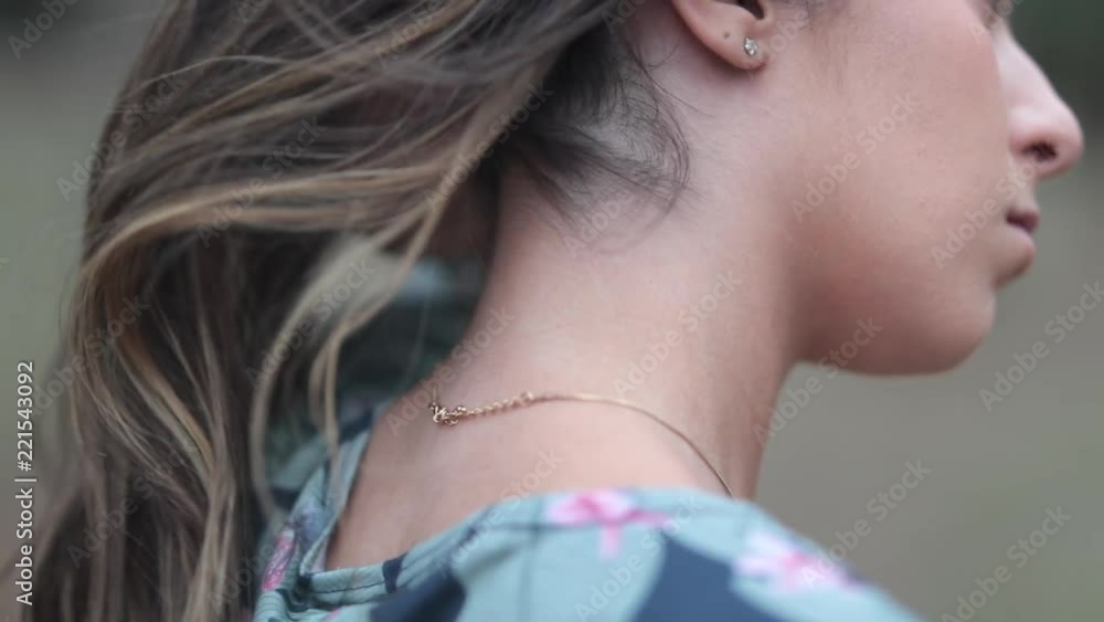 Girl adjusting hair showing neck Stock Video Adobe Stock