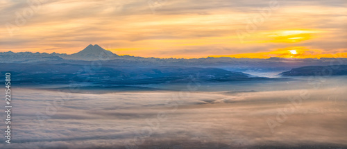 Mountains in the fog  haze. The Main Caucasian Range. Multicolored background. Mountains at sunset. Winter fog.