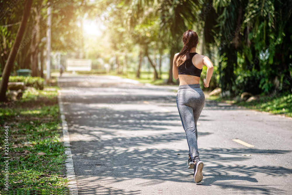 Pretty sport woman jogging in the park