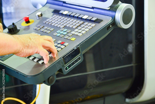 The control panel of the program of work on the control panel of the precision CNC machining center, the processing of the manufacturing process of the metal product at the factory.