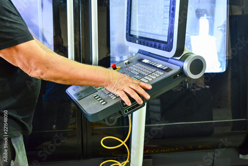 The control panel of the program of work on the control panel of the precision CNC machining center, the processing of the manufacturing process of the metal product at the factory.