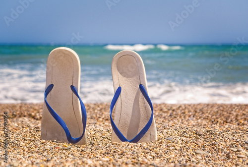 Flip flops on the beach with small stones