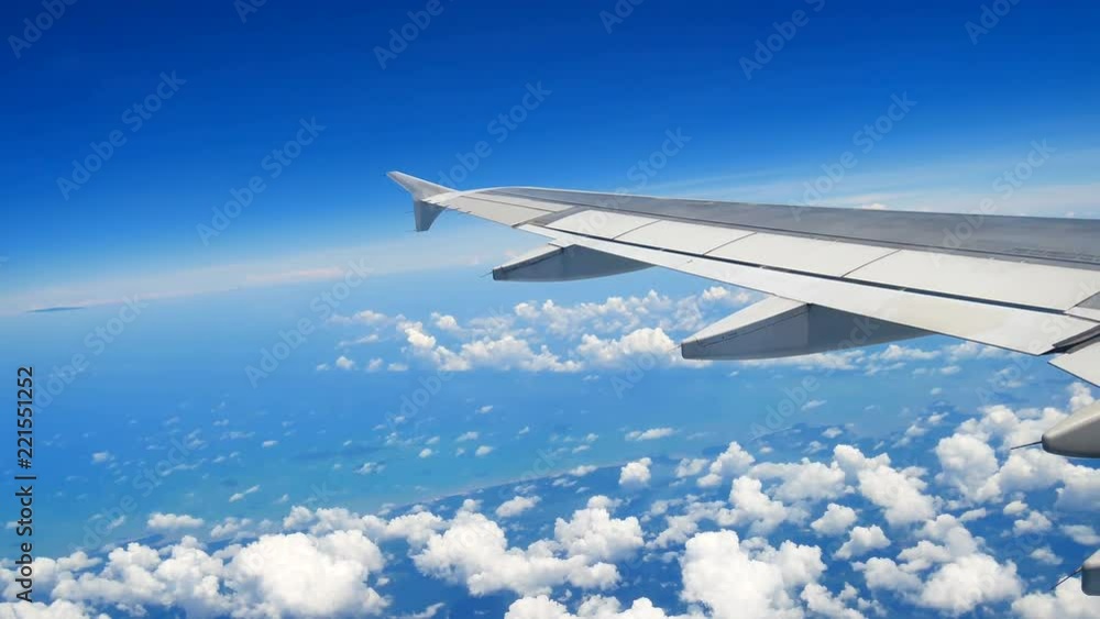 Travel Video View from the airplane window over the wings and engines The aircraft are flying through a cloud and Good weather On the go to Chiang Mai. in transportation concept. Travel Video View from the airplane window over the wings and engines The aircraft are flying through a cloud and Good weather On the go to Chiang Mai. in transportation concept.