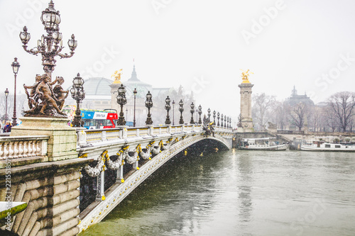 The Alexander III Bridge across Seine river in Paris in snow. Paris