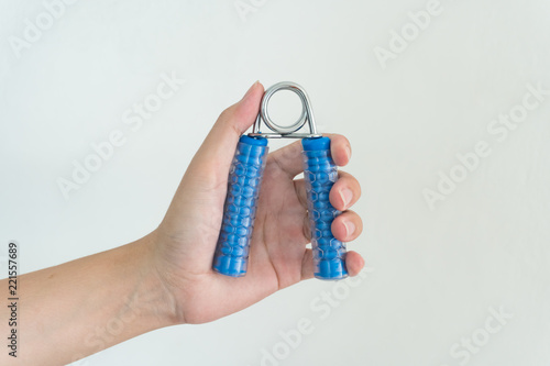 Canvas Print Hand holding gripper on white background