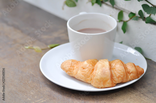 croissant and hot cocoa on the table
