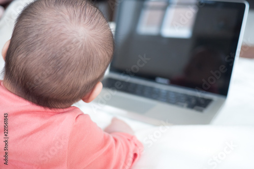 New born Baby and Laptop Computer : Concept of Kid and technology