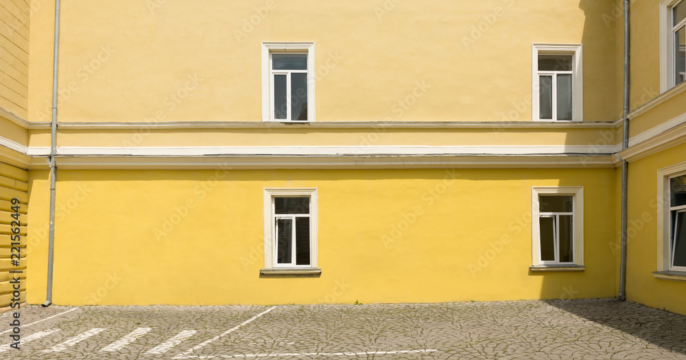 Traditional classic European restored school building facade with windows, panorama