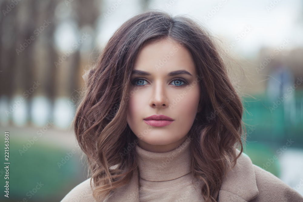 Perfect young woman face on nature background, closeup portrait. Gorgeous woman with curly hairstyle outdoors Perfect young woman face on nature background, closeup portrait. Gorgeous woman with curly hairstyle outdoors