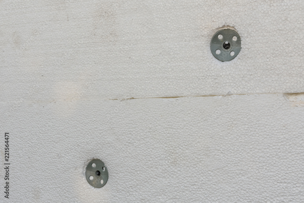 Insulation of the house with styrofoam. Energy saving concept. Closeup Insulation of the house with styrofoam. Energy saving concept. Closeup