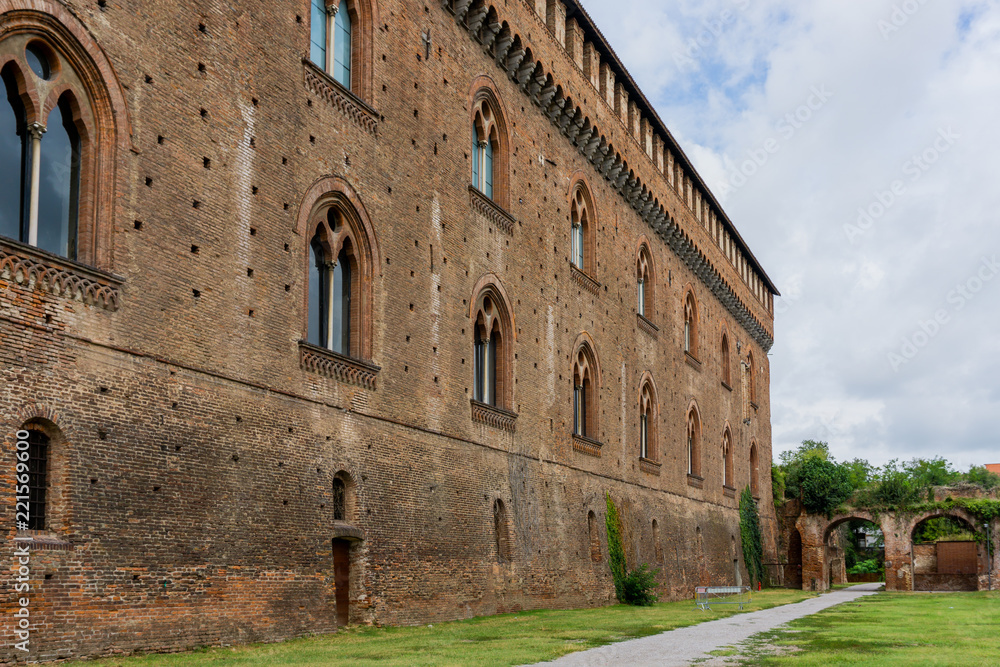 The facade of the Visconti Castle ( castello visconteo ). Medieval building with red brick facades in Pavia, Lombardy, Italy