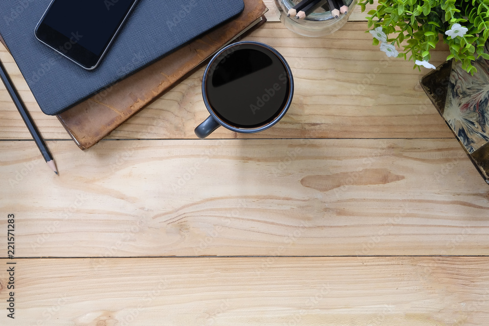Office desk a coffee, book, pencil and smartphone on copy space workspace table top view with wood texture. Office desk a coffee, book, pencil and smartphone on copy space workspace table top view with wood texture.
