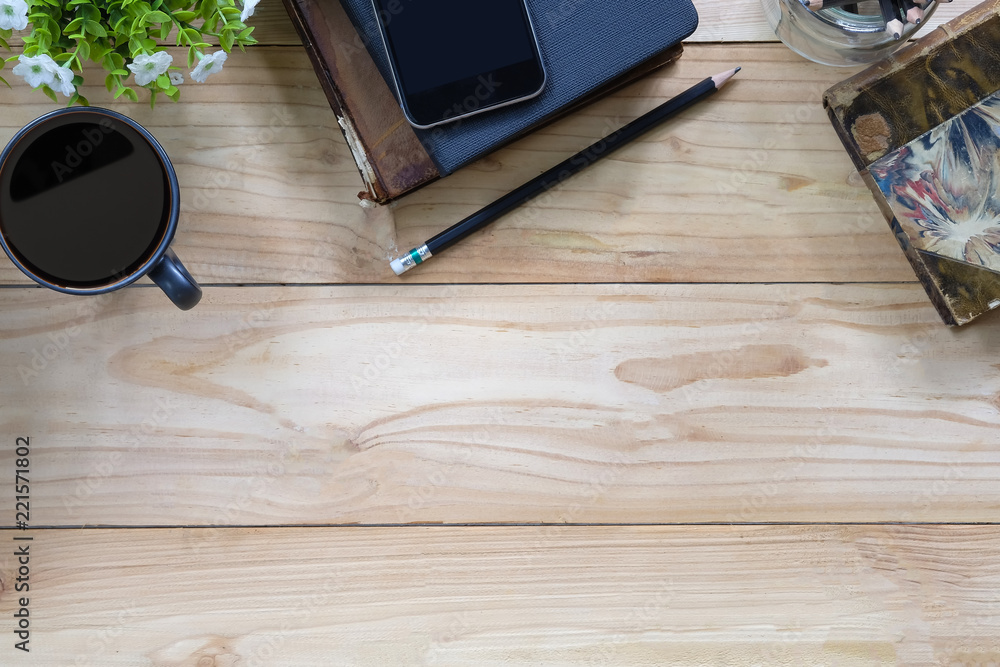 Office desk a coffee, book, pencil and smartphone on copy space workspace table top view with wood texture. Office desk a coffee, book, pencil and smartphone on copy space workspace table top view with wood texture.