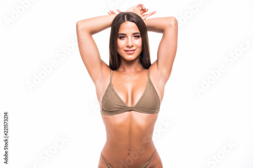 Sexy young brunette woman with a beautiful smile posing in a bikini isolated on white background © F8  \ Suport Ukraine