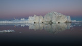Greenland midnight moonrise panorama with icebergs and pink sky