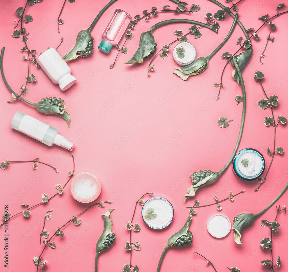 Beauty frame with various facial cosmetic products with mock up, leaves and  green flowers on pastel pink desktop background. Modern skin care layout,  top view Stock Photo | Adobe Stock