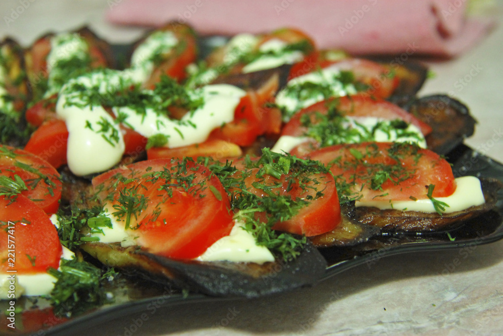 Fried eggplants and fresh tomato with souce and herbs Fried eggplants and fresh tomato with souce and herbs