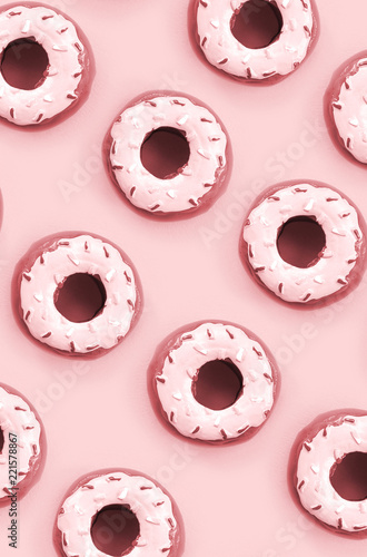 Many small plastic donuts lies on a pastel colorful background. Flat lay minimal pattern. Top view photo