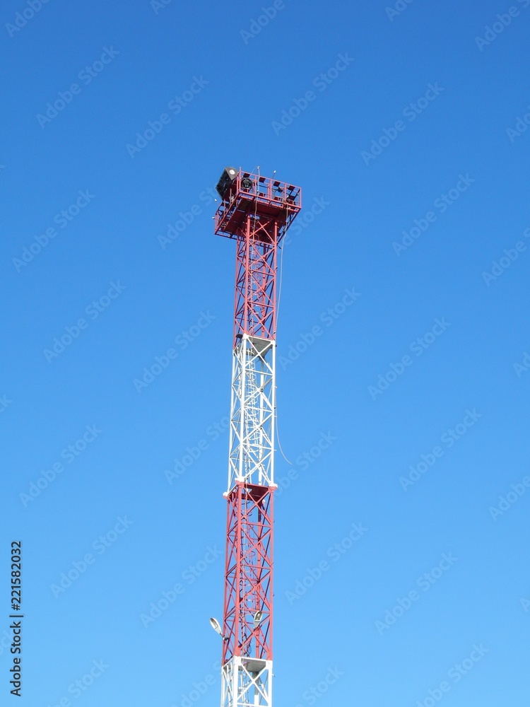 High metal support with lighting projectors. Tower for lighting the territory. A photo. High metal support with lighting projectors. Tower for lighting the territory. A photo.