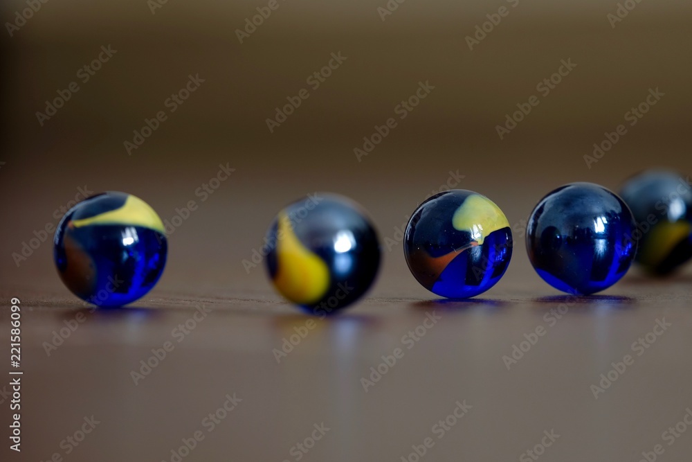 glass Marbles on dark wooden floor glass Marbles on dark wooden floor