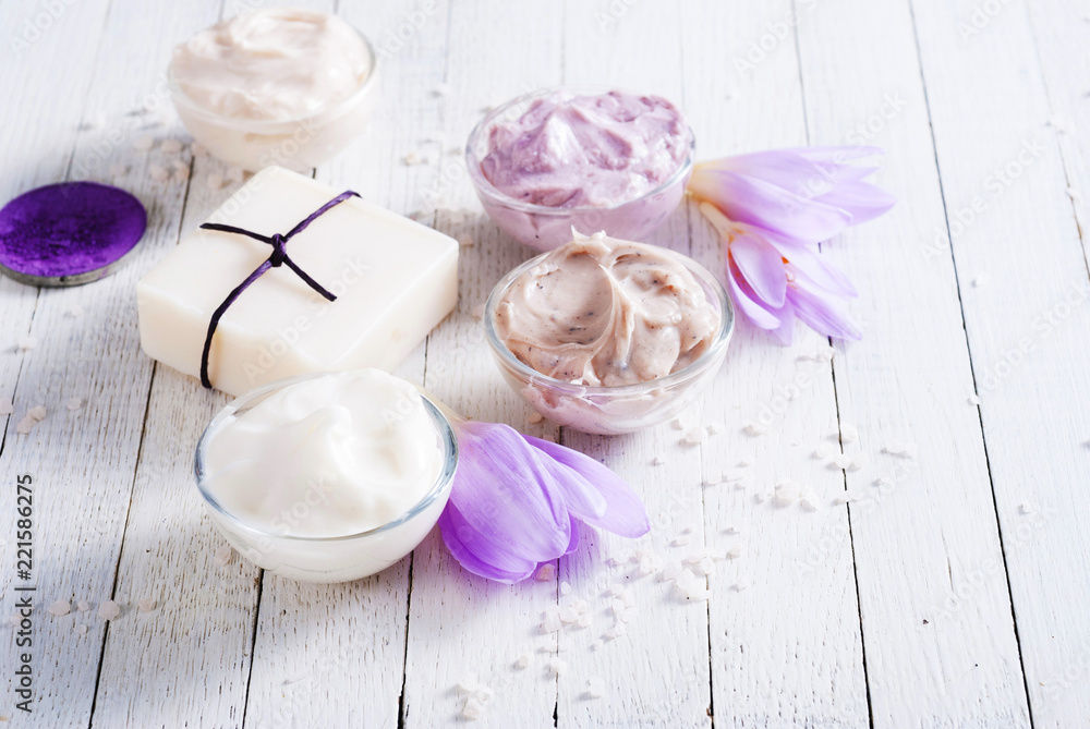 cosmetic cream variations, soap and bath salt with autumn crocus herbal flower on white wooden table