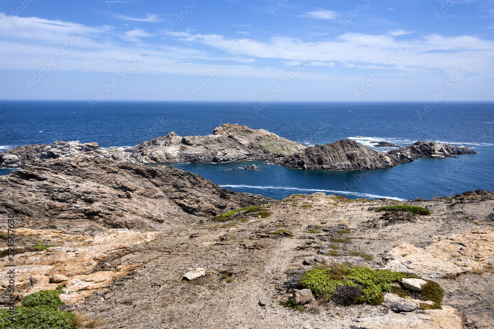 Spain, Catalonia, Cap de Creus: Panorama view of famous beautiful Spanish tourist destination with rocky cliff, laguna, blue sea water and cloudy sky in the background - concept nature.
